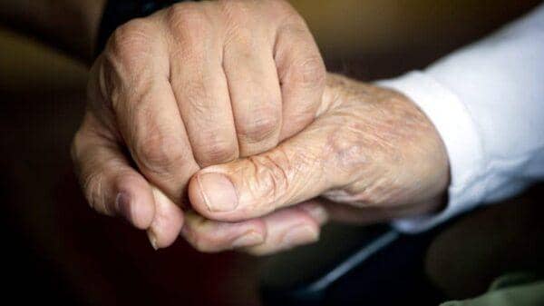Elderly hands clasping, symbolizing support and care. Routine check-ups, medication management, specialist care, therapy, mental health, nutrition, home health, and preventive care are essential for senior health, supported by ETH.
