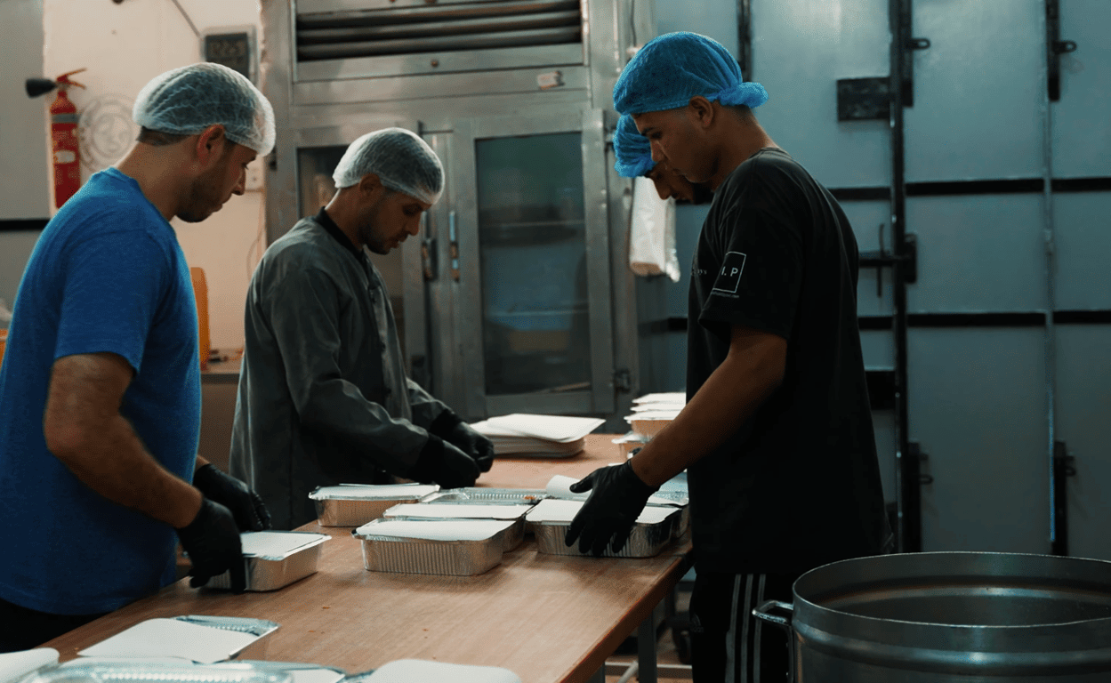 Volunteers preparing food packages for Palestine relief efforts. Aid distributed using WBTC.