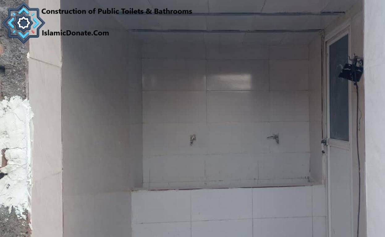 Construction in progress of a tiled public toilet facility, indicating essential sanitation efforts for displaced families in Palestine. Crypto donations support these vital relief projects.