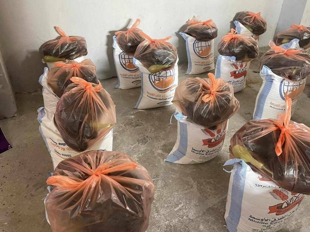 Bags of food supplies ready for distribution, with one bag showing 'Middle East Flour' branding. Crypto donations like Tether ensure urgent aid reaches displaced families in Palestine. Supports food scarcity relief.