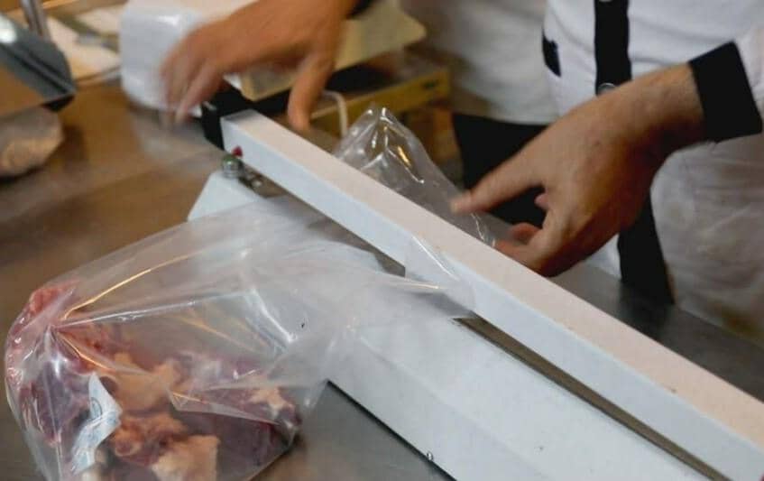 Sealing packages of sacrificial meat for distribution, supported by ETH donations, ensuring sustenance and dignity for vulnerable communities during Eid al-Adha.