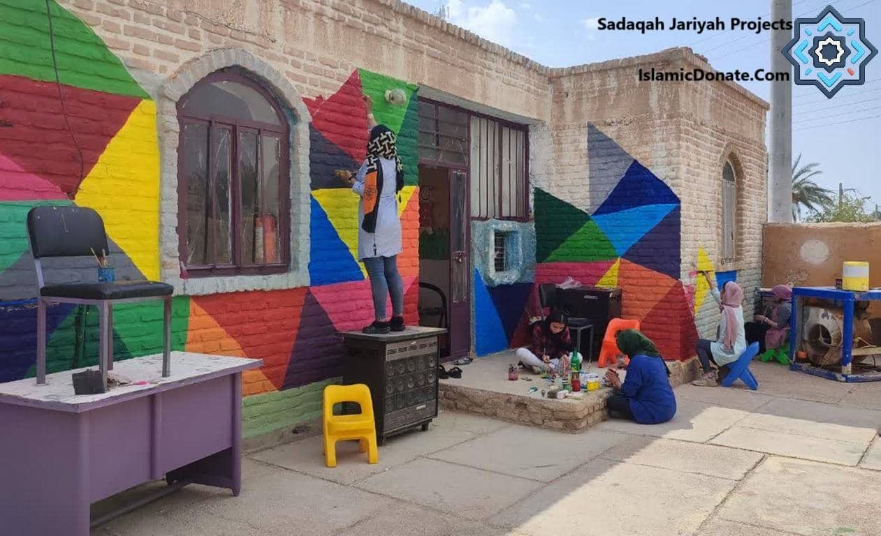 Children painting a colorful mural on a building wall, symbolizing education and community development projects funded by crypto donations.