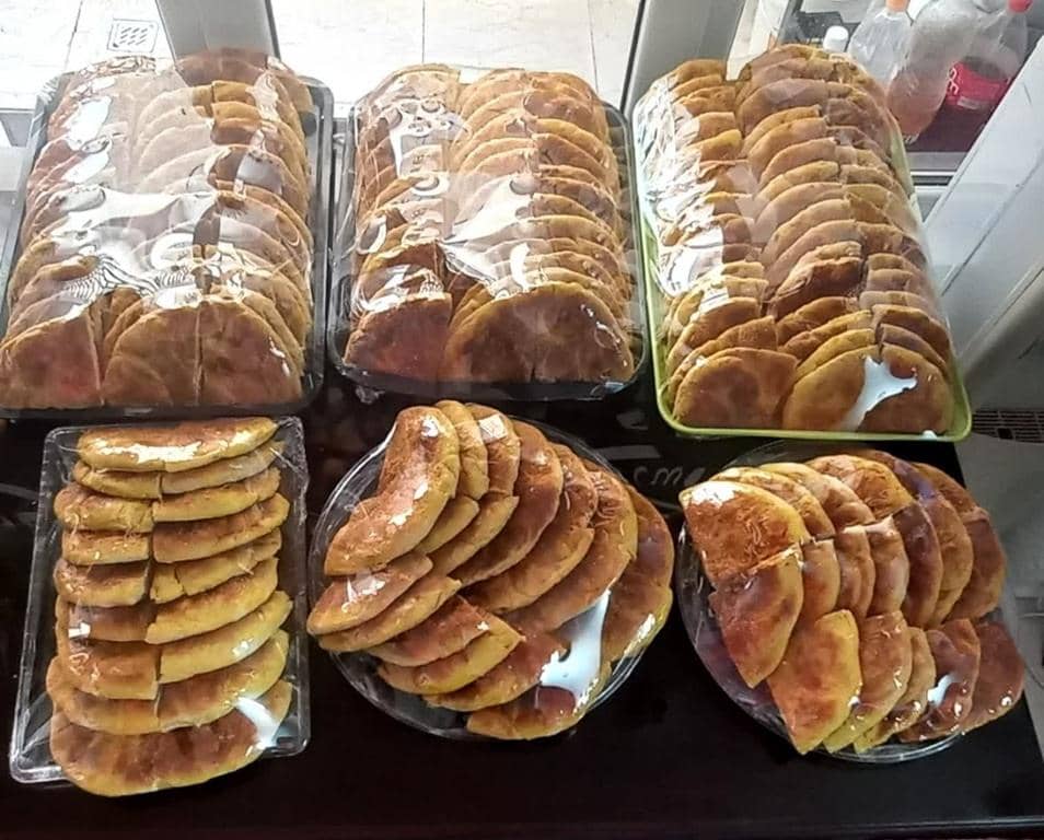 Stacks of golden-brown, folded flatbreads or pastries, wrapped in plastic, showing a generous portion of Iftar meals offered for Ramadan. Your crypto donation provides these vital food packages, supported by Bitcoin, supporting the Muslim Ummah in Gaza and Palestine.