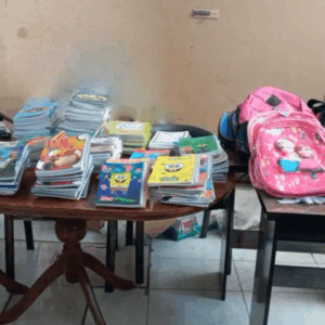 Back to School Report 2024: Piles of notebooks, pencils, and school supplies including backpacks and bottles of sanitizer, ready for distribution to sponsored orphans, made possible by crypto donations like BTC, fostering education and potential.
