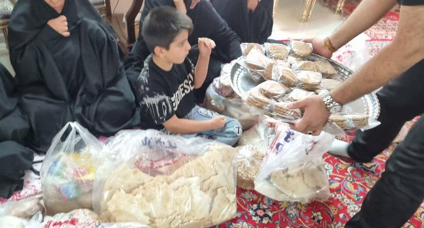 A boy sits with bags of food and traditional sweets while a platter of sweets is offered, celebrating Mawlid generosity with crypto donations via RLUSD.