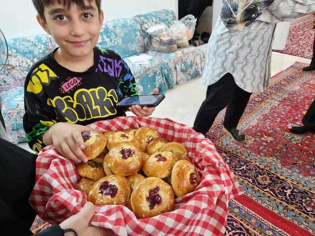 Boy holding a basket of freshly baked sweets for Prophet's birthday celebration, with crypto donations supporting community generosity in ETH.