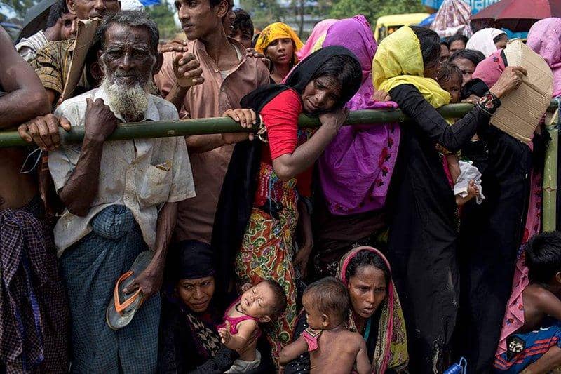Bangladeshi Muslims in need seeking aid, with a woman holding a child receiving support through cryptocurrency donations, like Ethereum.