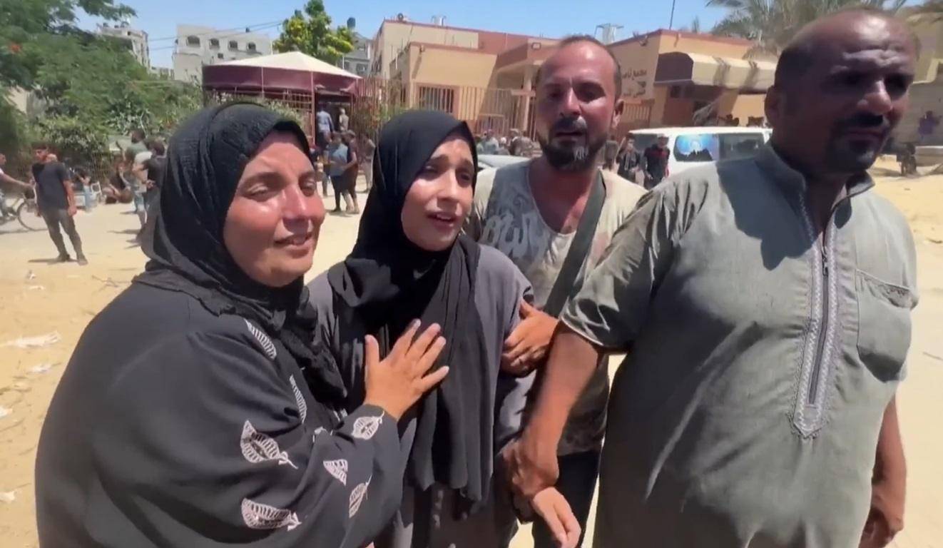 Gaza family in distress, receiving aid. Humanitarian efforts in Gaza continue, with crypto donations like USDC supporting urgent relief for families.