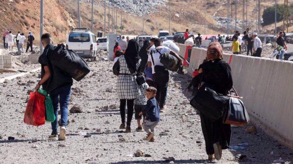 Baalbek Lebanon crisis: Displaced families, including vulnerable women and children, walk with belongings. Donate crypto like USDT for essential aid, food, and shelter to support the Muslim Ummah facing conflict and displacement.