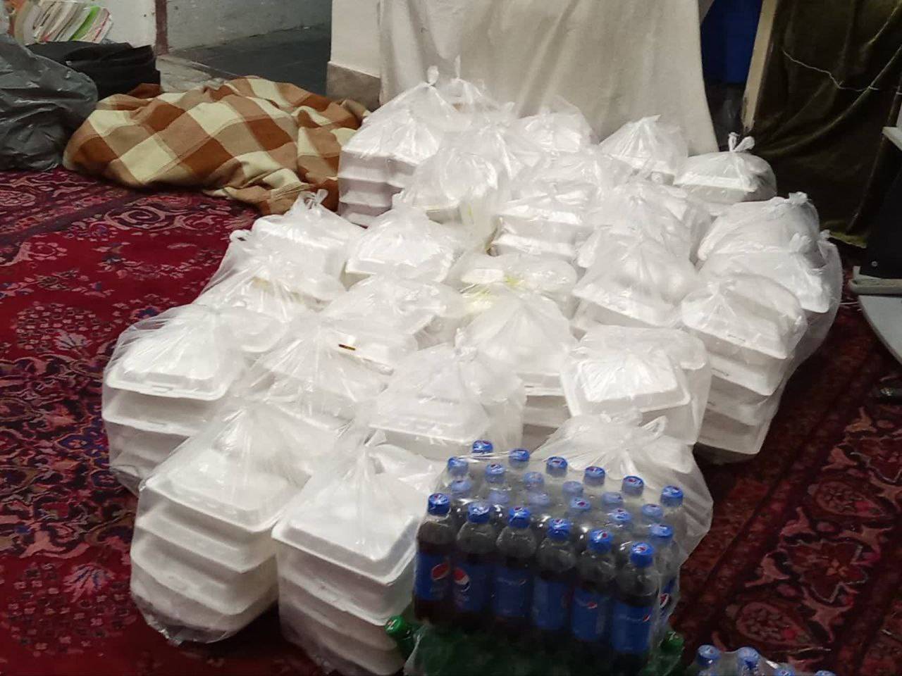 Stacks of white foam food containers and bottles of soda ready for distribution, symbolizing crypto Zakat aid via ETH donation for those in need.