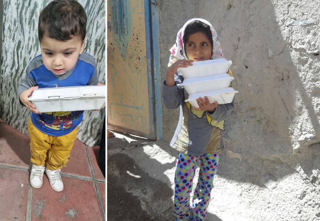 Two children, a young boy and a girl, hold containers of food. The boy wears a blue and grey shirt and yellow pants, carrying one container. The girl, in a headscarf and colorful pants, carries a stack of three containers. Serving food to the needy with ETH donations.