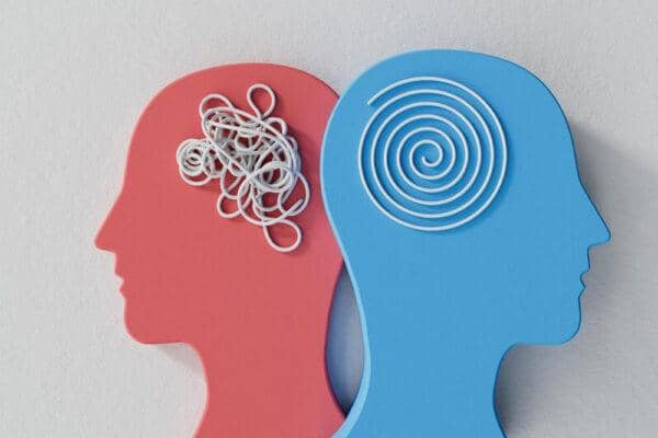 Two profiles representing mental states: one red with a tangled mess of white lines, the other blue with a neat spiral, symbolizing the journey from distress to peace in holistic well-being, with support from crypto donations like Bitcoin.