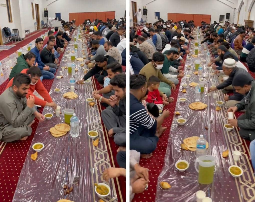 Men and children seated on the floor for iftar, enjoying a communal meal during Ramadan, with food and drinks laid out on plastic sheeting. Their donations, potentially via BTC, support such relief efforts.