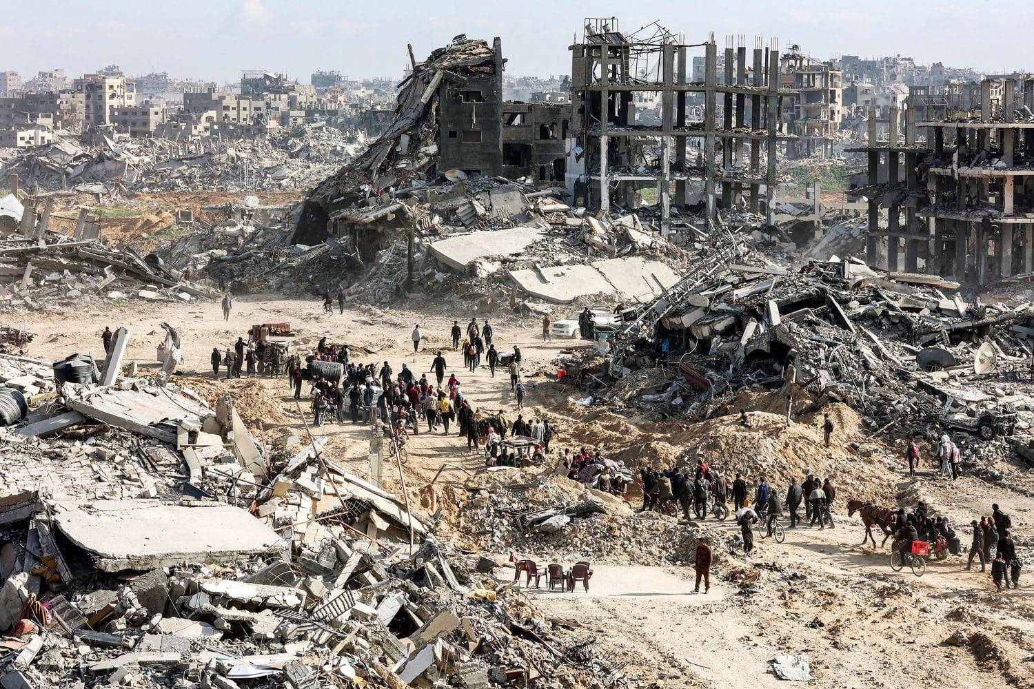 Devastation in Gaza with people sifting through rubble. Urgent aid for Palestine, including essential supplies and crypto donations via USDT.