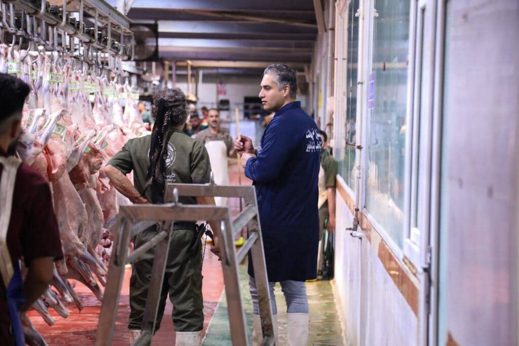 Workers in a clean facility inspect halal meat supplies for distribution to the needy during Ramadan, supported by crypto donations via ETH.