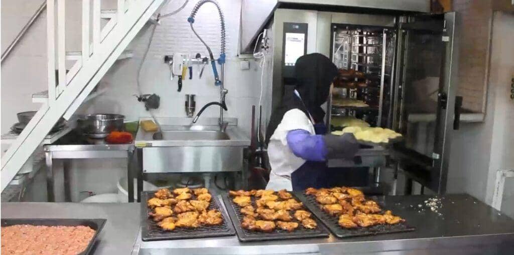 Halima, a devoted cook, prepares Iftar meals in a kitchen, showcasing her dedication to feeding the needy, with support from crypto donations like SOL.