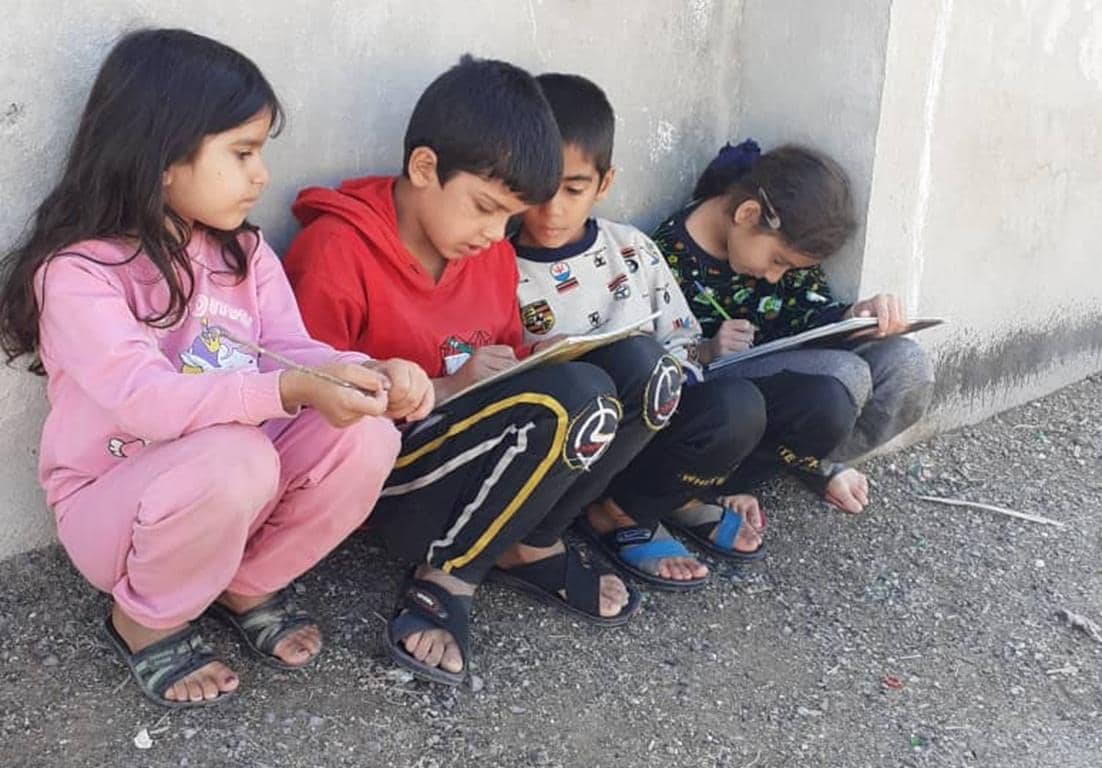 Children in Palestine learning and writing, supported by crypto zakat donations, fulfilling Islamic duty and saving Palestinian Muslims. Crypto Zakat for education aids.
