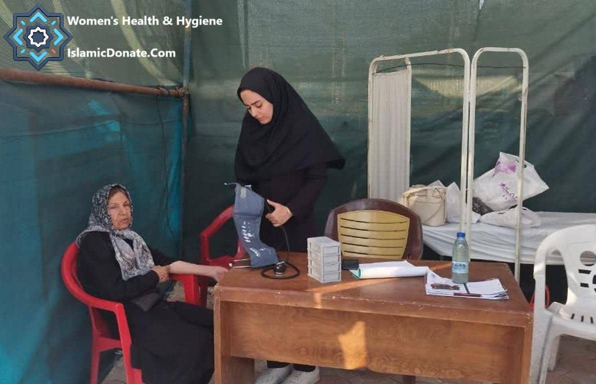 Woman having blood pressure checked by nurse at a mobile clinic providing women's health and hygiene services, supported by crypto Zakat donations like ETH for Palestine.