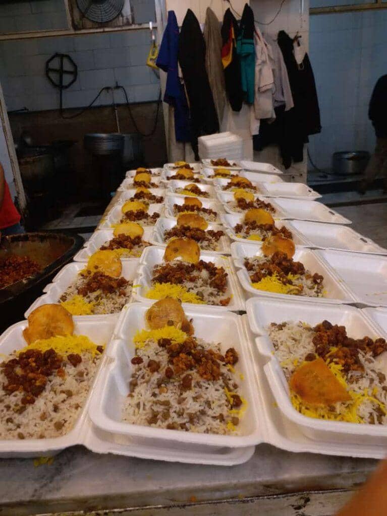 Row upon row of white styrofoam containers filled with rice, lentils, and a meat topping, awaiting distribution for Iftar and Suhoor meals in the Middle East and Mediterranean regions. This Zakat donation is supported by ETH.
