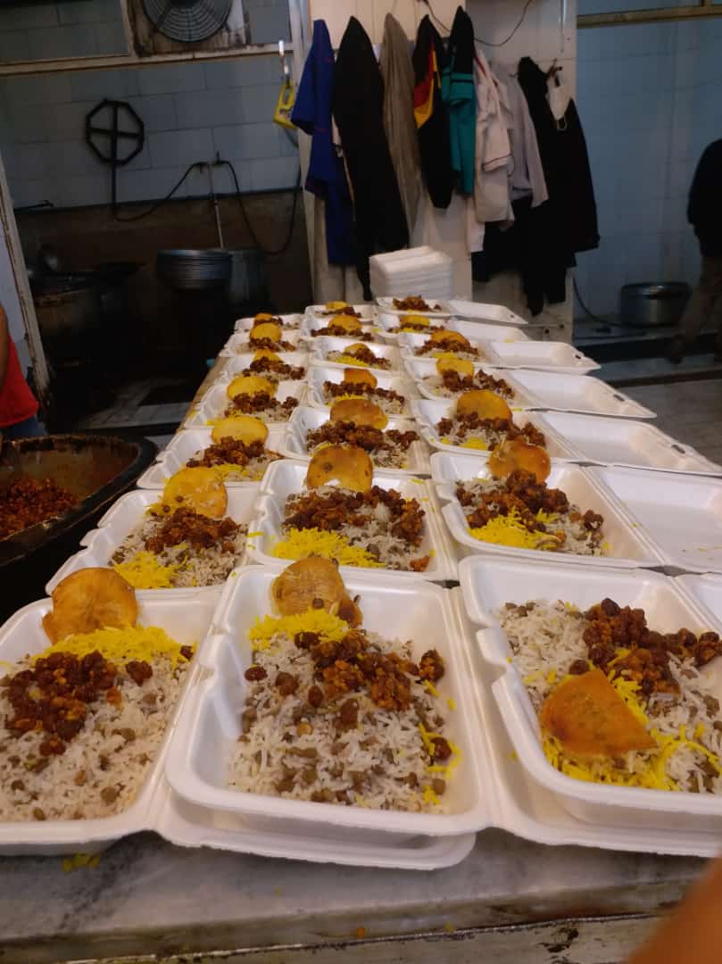 Row upon row of white styrofoam containers filled with rice, lentils, and a meat topping, awaiting distribution for Iftar and Suhoor meals in the Middle East and Mediterranean regions. This Zakat donation is supported by ETH.