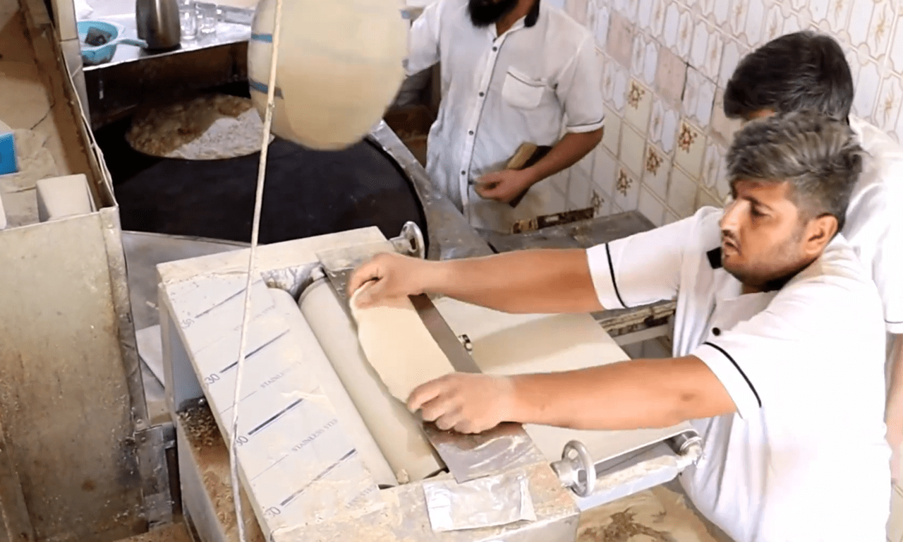 Bakers prepare dough with a bread-making machine, a process vital for delivering sustenance and hope to Palestine with crypto donations like Bitcoin.