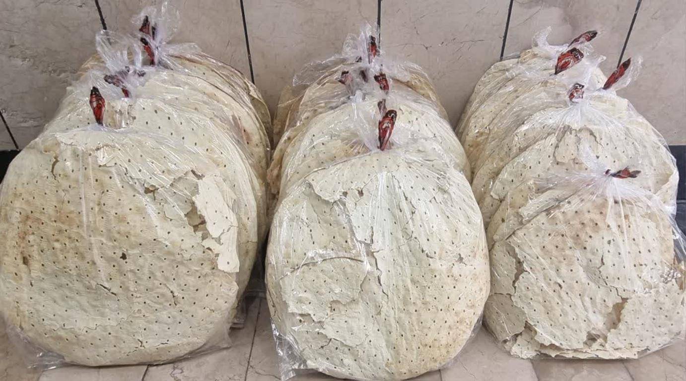 Stacks of large, thin, round flatbreads packaged in clear plastic bags, ready for distribution. These loaves symbolize resilience and hope for Palestinians, with donations supporting aid efforts via crypto like USDT.