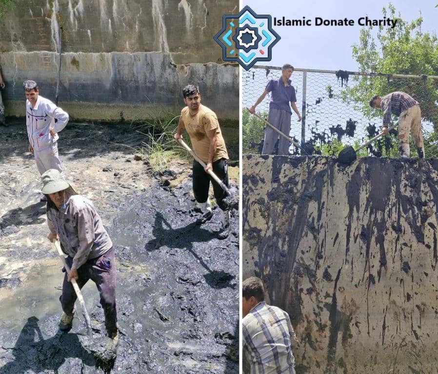 Men cleaning thick mud from a water channel, symbolizing ongoing charity and water system maintenance supported by crypto donations like BTC.
