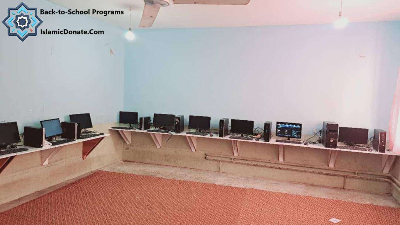 Row of desktop computers on shelves in a room, part of Back-to-School Programs for anonymous crypto donations supporting education with Bitcoin.