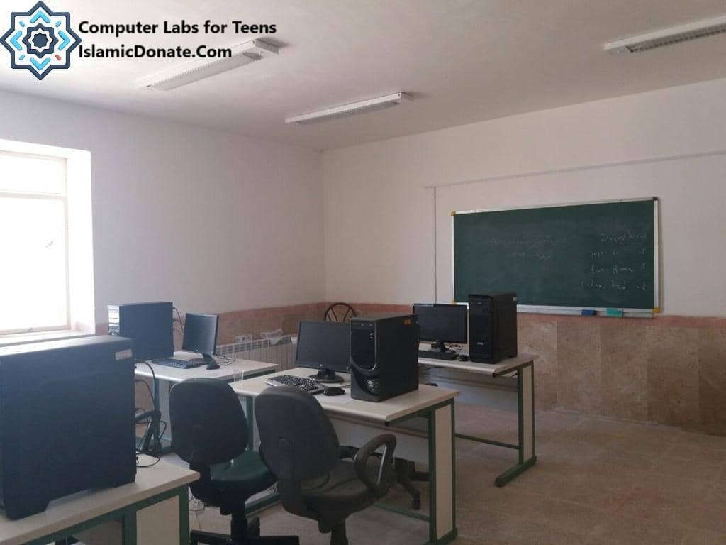 Computer lab for teens with desks, chairs, and computers, supported by crypto donations to provide digital literacy and educational support.