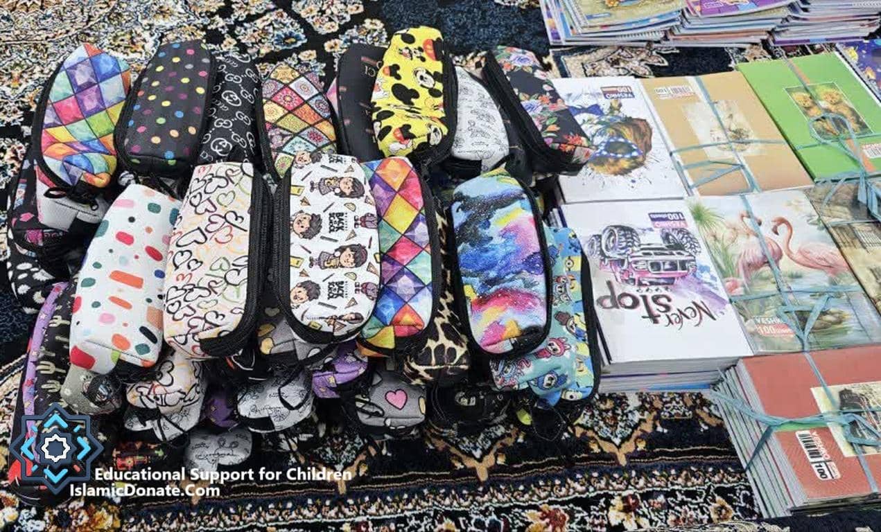 Pile of colorful pencil cases and notebooks for educational support for children, funded by BTC donations.