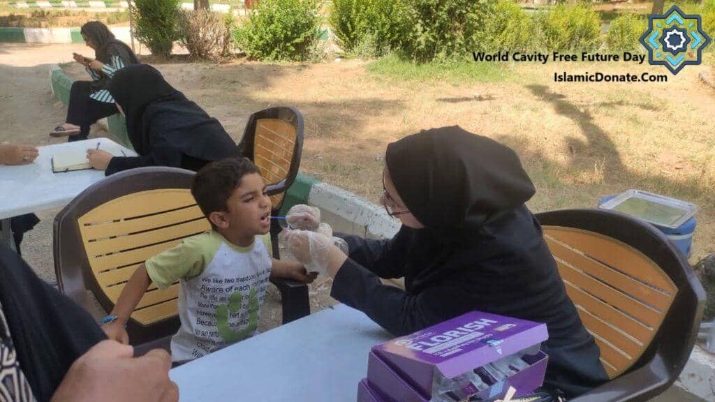 World Cavity-Free Future Day initiative, a medical professional checks a child's teeth. Crypto donations, likely via BTC, support this vital oral hygiene education effort for children's health.
