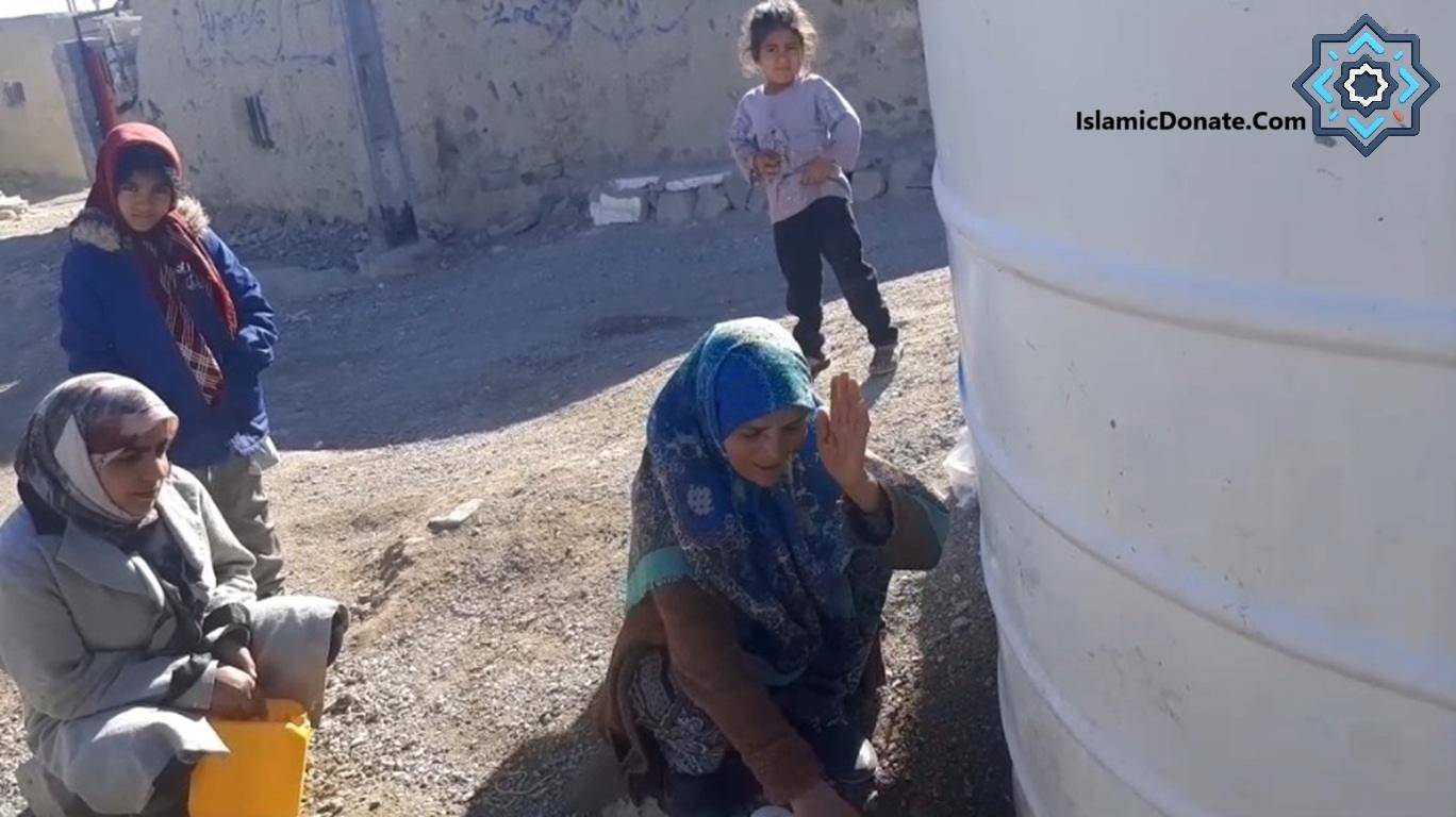 A woman collects water from a tank as children watch, symbolizing the impact of crypto donations for clean water projects with blockchains like ETH or BNB.