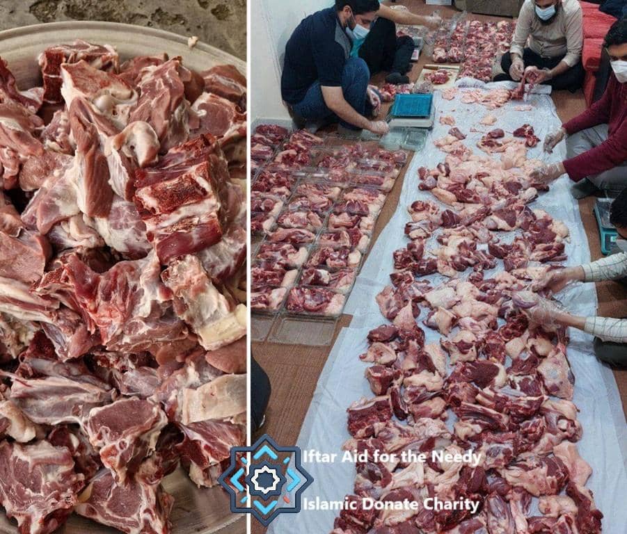 Freshly processed sacrificial meat in containers and on a tarp, being portioned by individuals for Iftar Aid for the Needy by Islamic Donate Charity, supported by XRP donations.