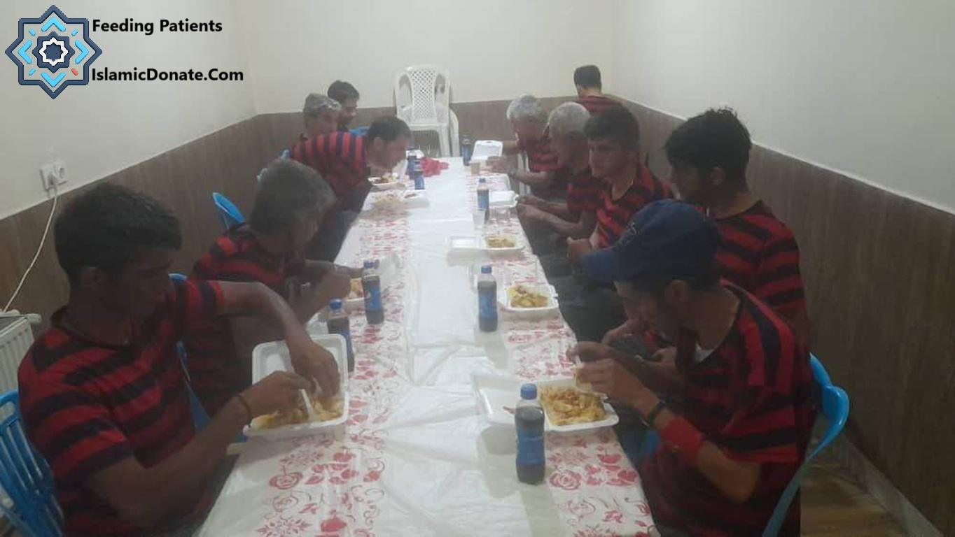 Group of boys eating meals at a long table, some wearing red and blue striped shirts. Islamic Donate Charity provides Kaffarah for feeding the poor with cryptocurrency like LTC.