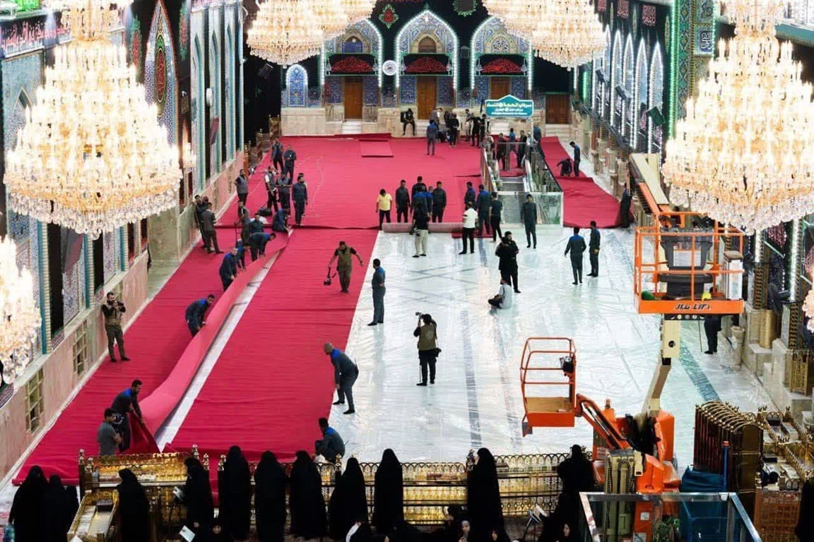 Imam Hussain's Nazr fulfillment via USDC. Workers layout red carpets in a shrine to serve humanitarian needs and justice.