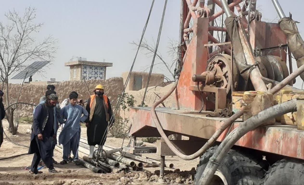 Drilling rig in Afghanistan, supporting water scarcity relief and community development through crypto donations like PayPal USD.