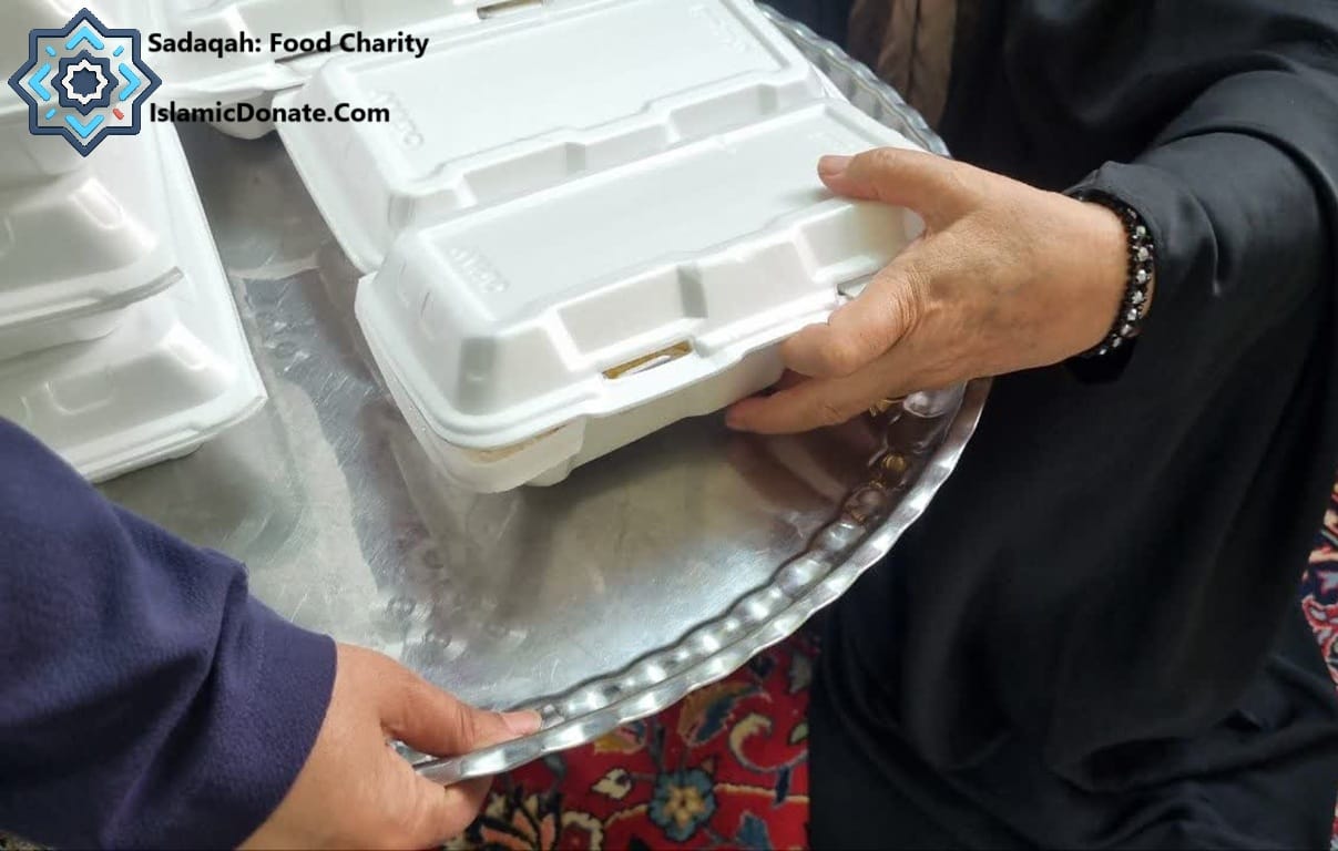 Food charity: Hands place white takeout containers on a silver tray. Daily Sadaqah with crypto, like PYUSD, provides meals for the needy.