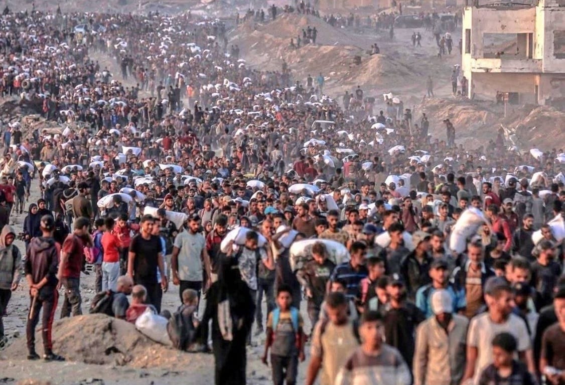 Crowd of people carrying belongings, representing need and charity with potential crypto donations like USDT.