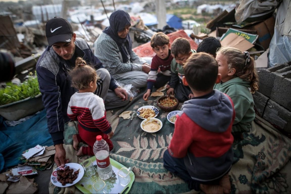 Help Rafah families eating together in ruins. Donate USDT to provide food aid and emergency relief to children in Gaza.