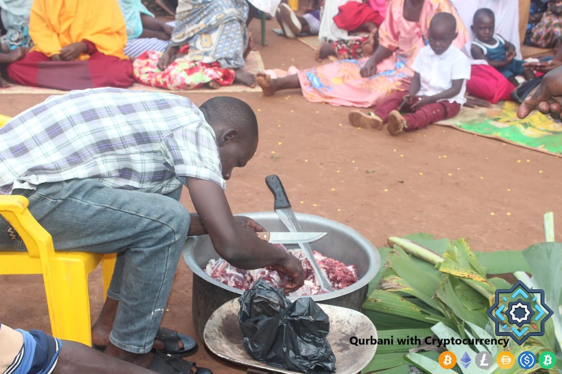 Man preparing Qurbani meat with knives in a large pot. Donors use cryptocurrency like ETH for halal giving to feed the needy this Eid al-Adha.