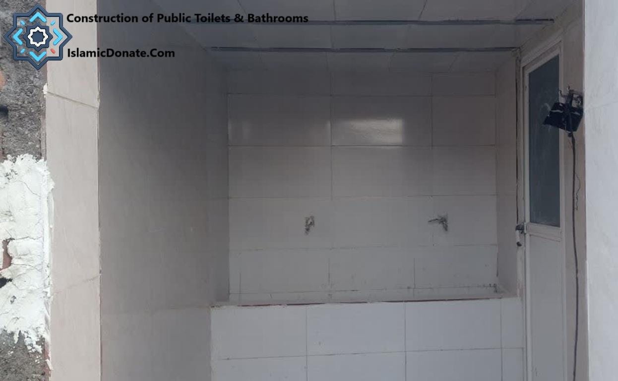 Construction in progress of a tiled public toilet facility, indicating essential sanitation efforts for displaced families in Palestine. Crypto donations support these vital relief projects.