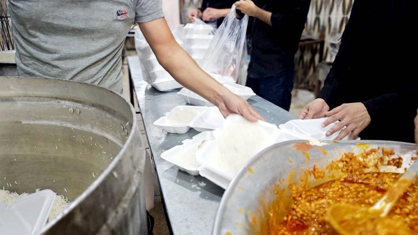 Volunteers distributing rice and meals to people in need, supporting the Muslim Ummah with crypto donations via SOL for food security.