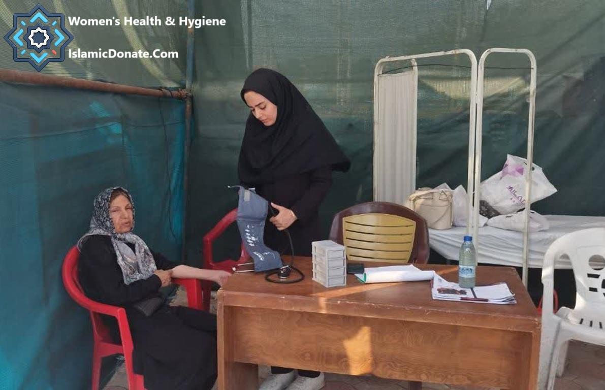 Woman having blood pressure checked by nurse at a mobile clinic providing women's health and hygiene services, supported by crypto Zakat donations like ETH for Palestine.