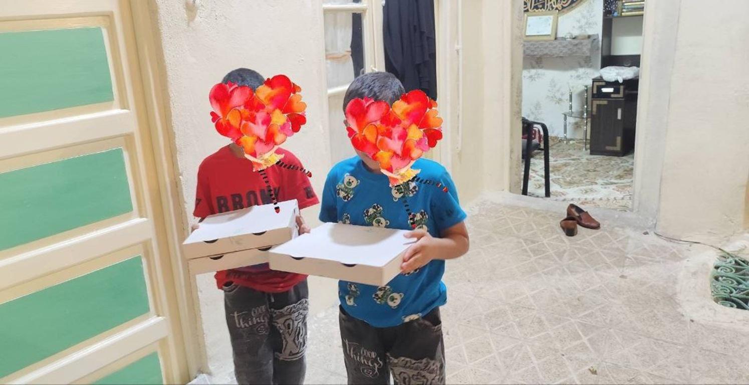 Two children holding pizza boxes, their faces obscured by floral heart designs, symbolizing children receiving pizza for the first time through crypto donations, specifically those in Palestine, Syria, and Lebanon, with the aid enabled by SOL.