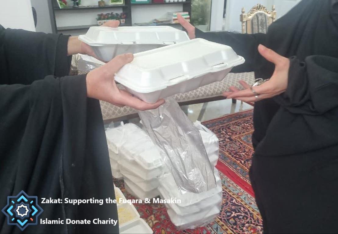 Zakat crypto donations providing meals for Fuqara and Masakin using ETH. Volnteer hands food containers to a woman.