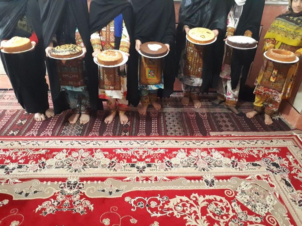Children in traditional clothing holding cakes to celebrate Eid al-Fitr after their first fast, with crypto donations supporting Islamic relief.