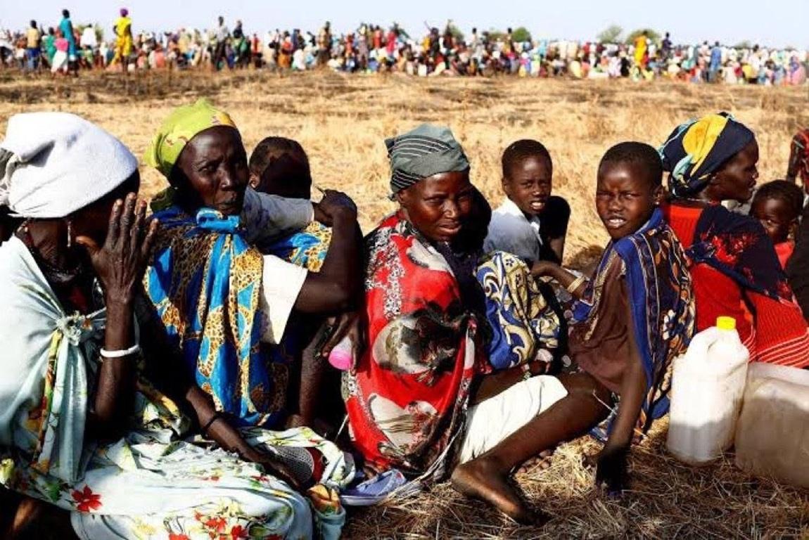 Ethiopia humanitarian crisis relief with USDC. Horn of Africa displacement camp families wait for food and water supplies.