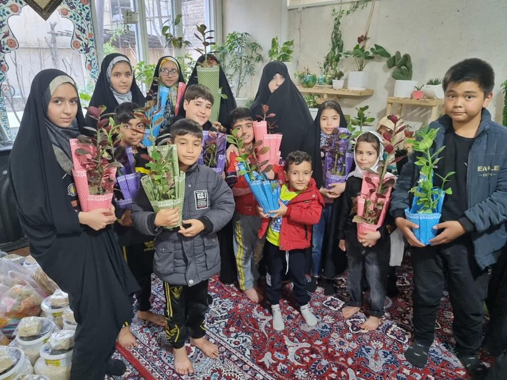 Children and adults holding potted plants, symbolizing Zakat al-Fitr donation, supported by Litecoin cryptocurrency for Ramadan charitable giving.