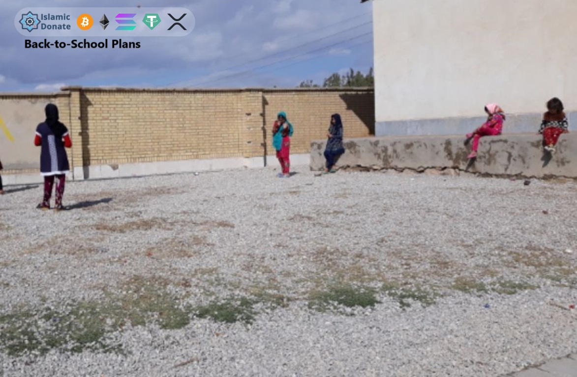 General literacy training Back-to-School Plans for students in gravel schoolyard, funded by USDC crypto donations.