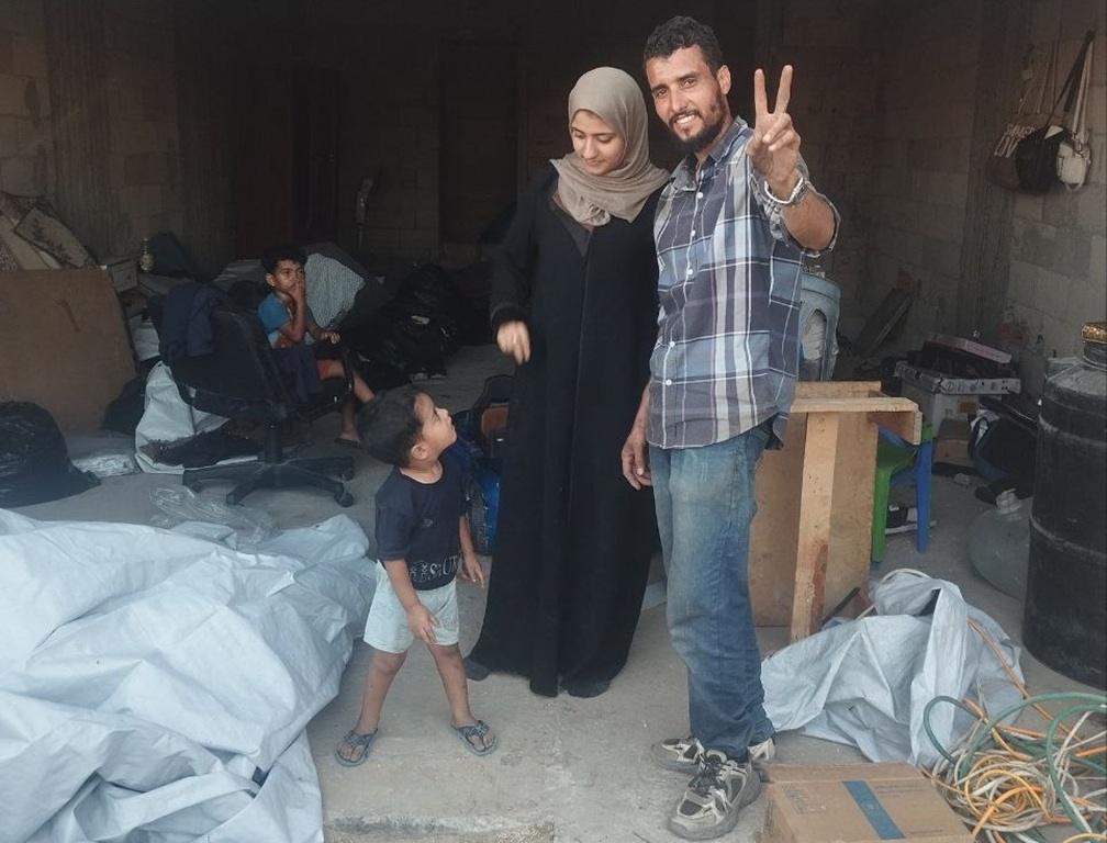 Palestinian family in makeshift shelter receives relief support funded by USDT islamic aid.